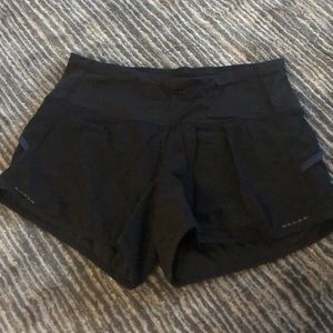 Black lululemon shorts with pink and navy detail